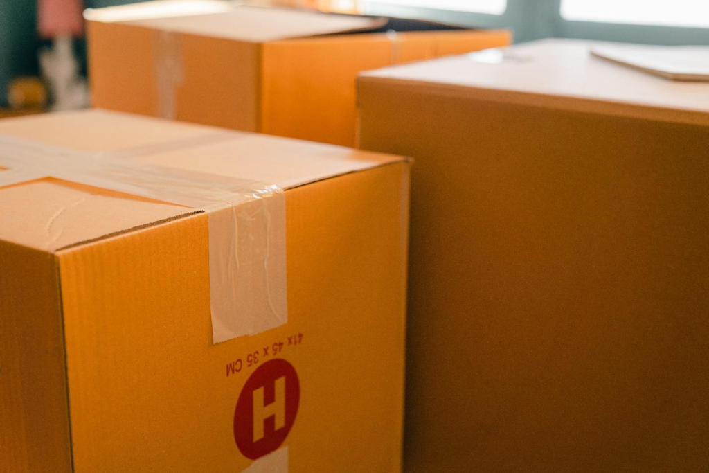 cardboard cartons sitting in a sunny room next to a window