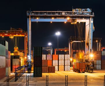 Industrial crane loading Containers in a Cargo freight ship