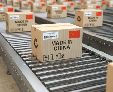 Made in China. Cardboard boxes with text made in China and chinese flag on the roller conveyor. 3d illustration