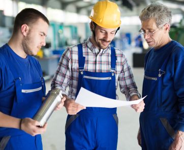 Mechanical and metal industry engineers working in factory